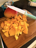 Fresh ripe mango cut into pieces by Coastal Freeze Co. before freeze-drying