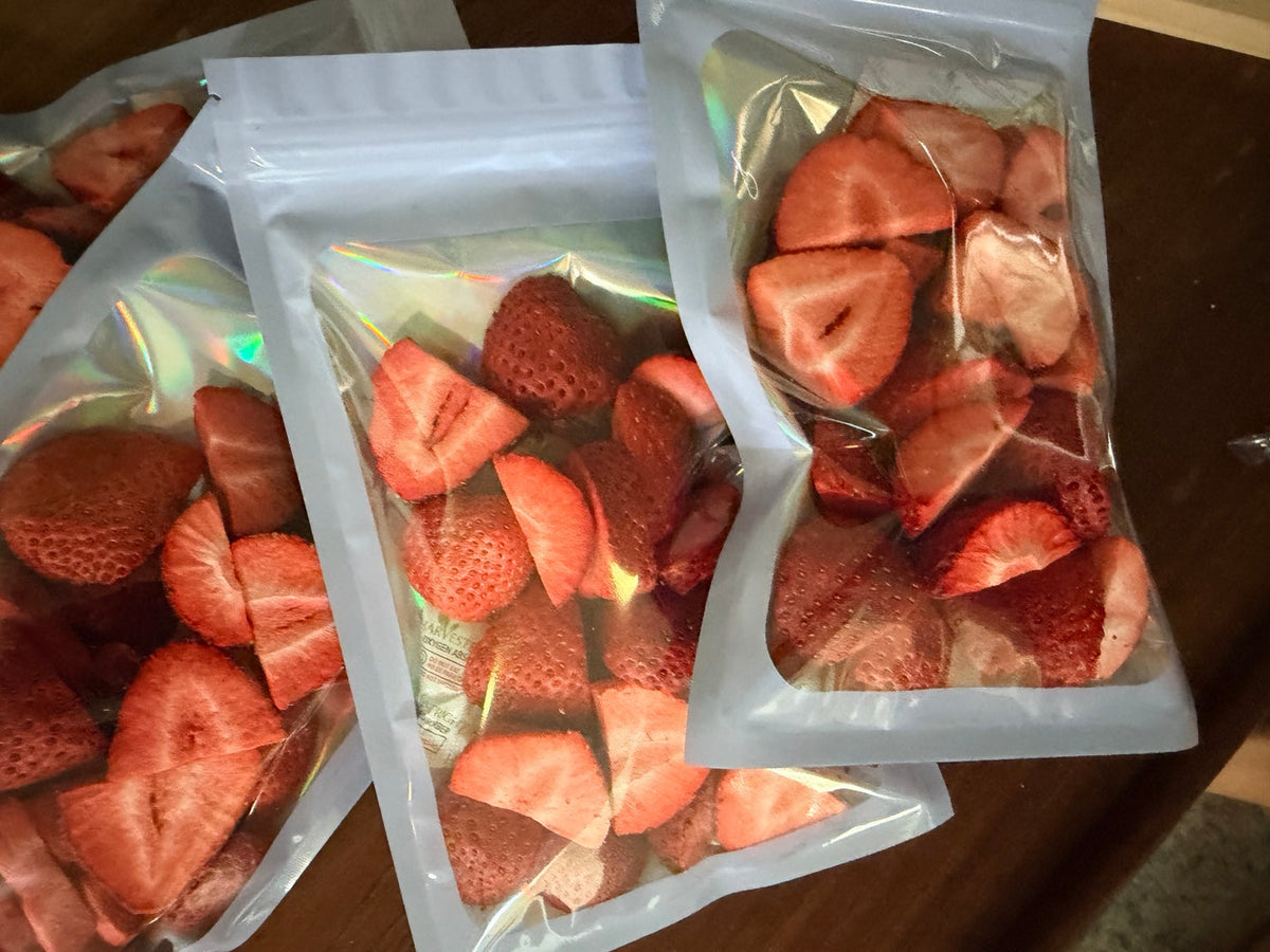 Three 0.5 oz pouches of Coastal Freeze freeze-dried strawberries